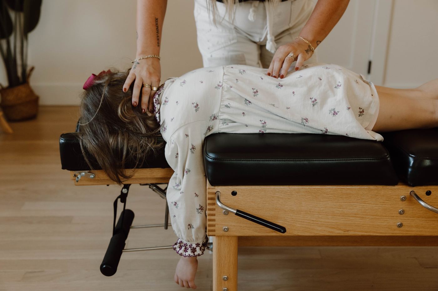 A young girl lying face down during a gentle pediatric adjustment