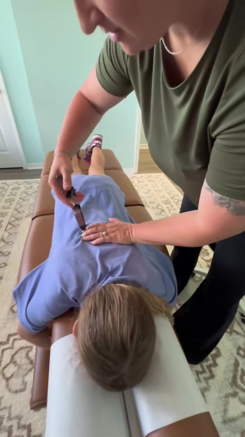 A gentle instrument adjustment on a child's back